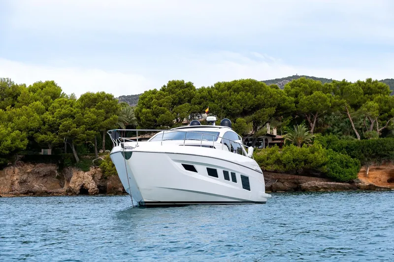  Yacht Photos Pics Luxury 2020 Filippetti S55S yacht anchored near lush green coastline.