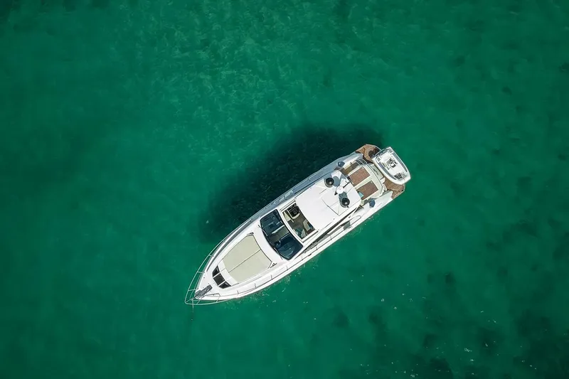  Yacht Photos Pics Aerial view of 2020 Filippetti S55S yacht on clear turquoise water.