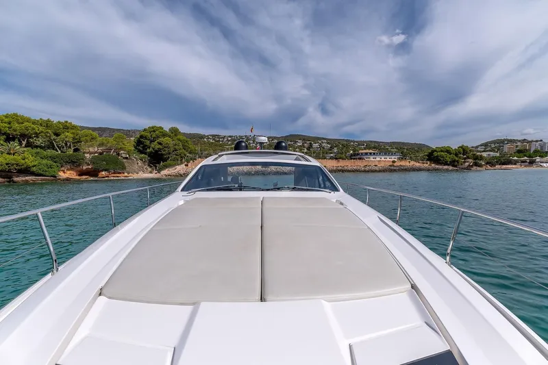  Yacht Photos Pics 2020 Filippetti S55S yacht cruising near scenic coastline under a partly cloudy sky.