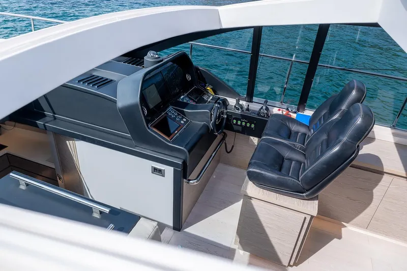  Yacht Photos Pics Luxury helm station of 2020 Filippetti S55S yacht with leather seats and modern controls.