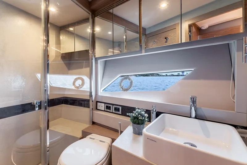  Yacht Photos Pics Luxurious bathroom interior of 2020 Filippetti S55S yacht with modern fixtures and sea view.