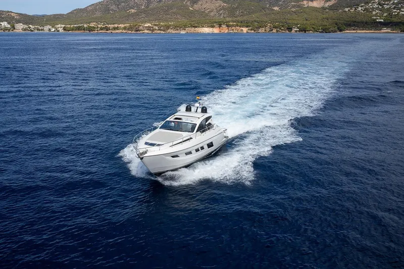  Yacht Photos Pics 2020 Filippetti S55S yacht cruising on open sea with scenic coastal backdrop.