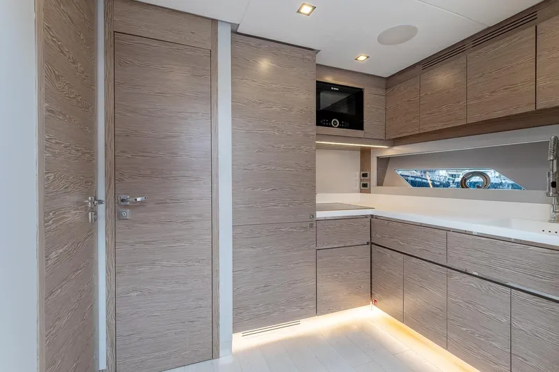  Yacht Photos Pics Modern kitchen interior of 2020 Filippetti S55S yacht with sleek wood cabinetry.