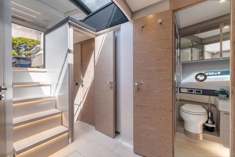  Yacht Photos Pics Luxurious interior of 2020 Filippetti S55S yacht with modern bathroom and staircase.