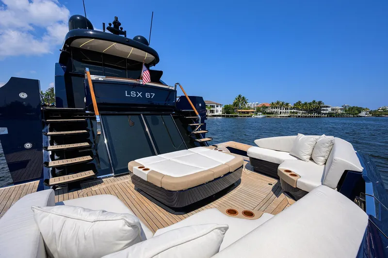 Lazzara Lsx 67 Yacht Photos Pics 2023 Lazzara LSX 67 yacht with luxurious deck seating and scenic waterfront view.