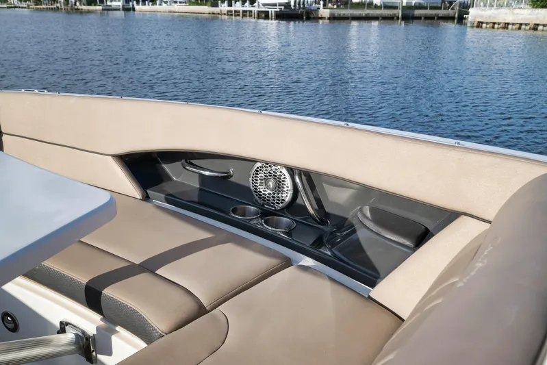  Yacht Photos Pics Interior of 2016 Sea Ray 350 SLX boat with seating and cup holders by the water.