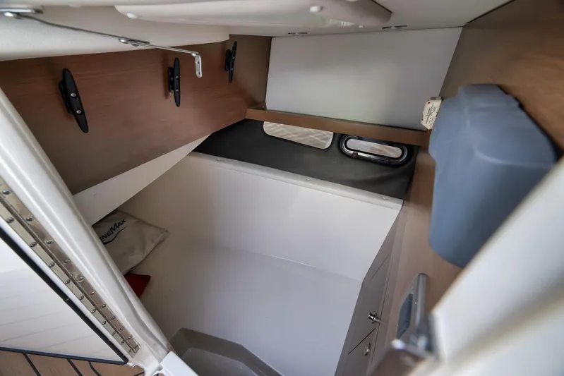  Yacht Photos Pics Interior cabin of 2016 Sea Ray 350 SLX boat, featuring compact storage and window.