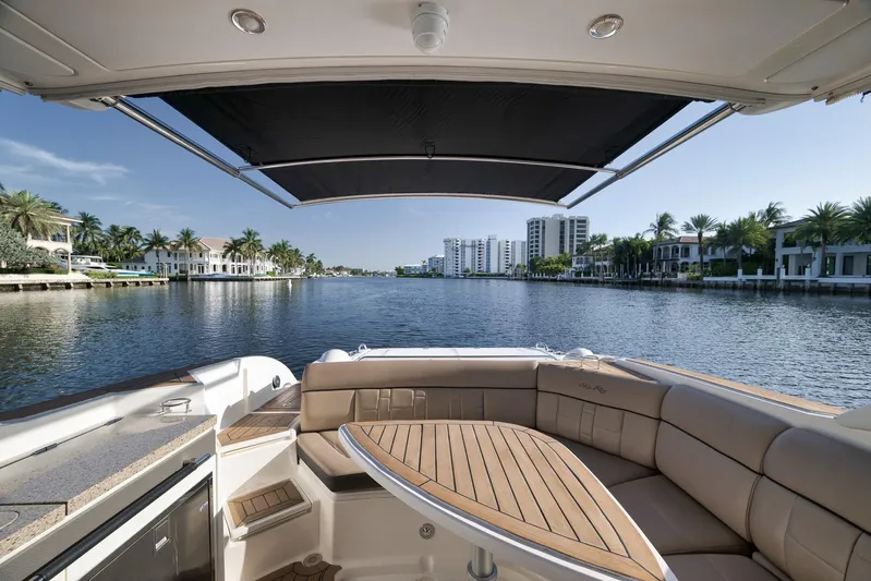  Yacht Photos Pics 2016 Sea Ray 350 SLX boat with luxurious seating, overlooking waterfront homes and palm trees.