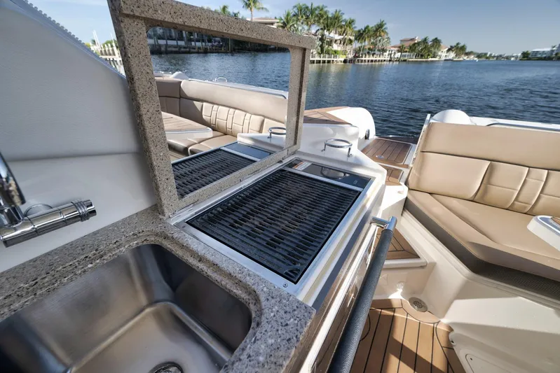  Yacht Photos Pics Luxury Sea Ray 350 SLX 2016 boat with onboard grill and sink, docked by scenic waterfront.