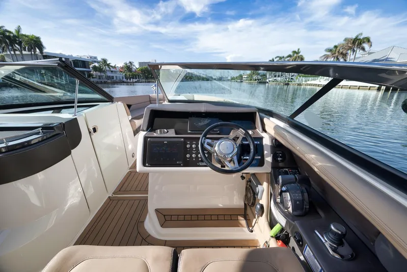  Yacht Photos Pics 2016 Sea Ray 350 SLX boat cockpit with modern controls, steering wheel, and waterfront view.