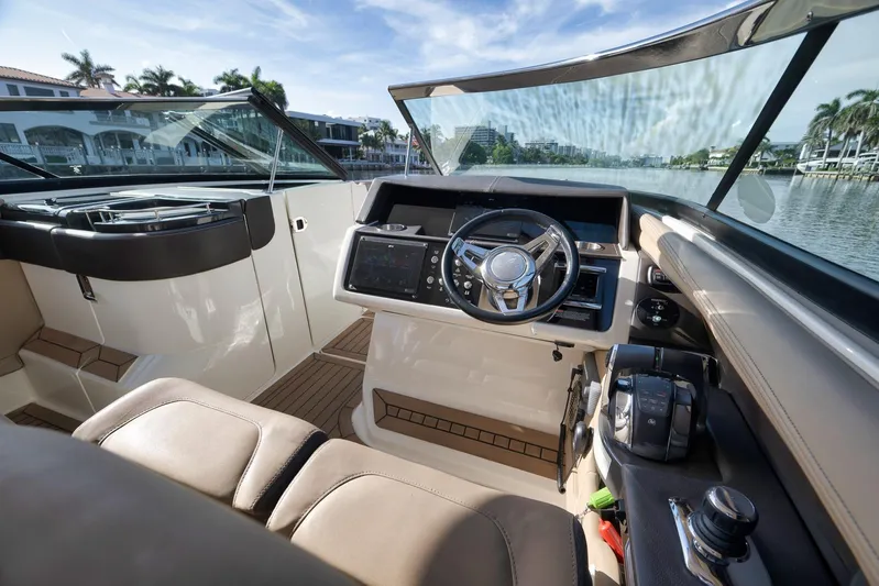  Yacht Photos Pics Interior view of 2016 Sea Ray 350 SLX boat cockpit with steering wheel and controls.