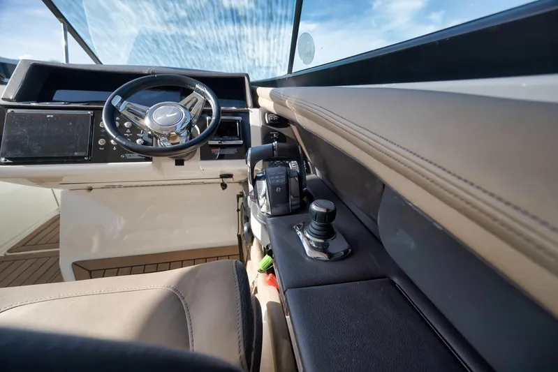  Yacht Photos Pics Interior view of 2016 Sea Ray 350 SLX boat cockpit with steering wheel and controls.