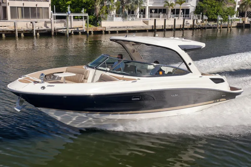  Yacht Photos Pics 2016 Sea Ray 350 SLX cruising on a sunny day, near waterfront homes.