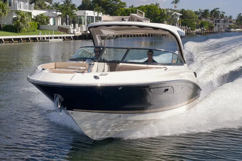  Yacht Photos Pics 2016 Sea Ray 350 SLX cruising on a scenic waterway, surrounded by luxury homes.