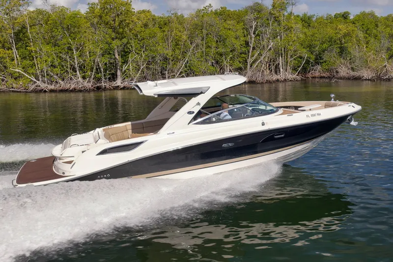  Yacht Photos Pics 2016 Sea Ray 350 SLX cruising on a calm river with lush green trees.