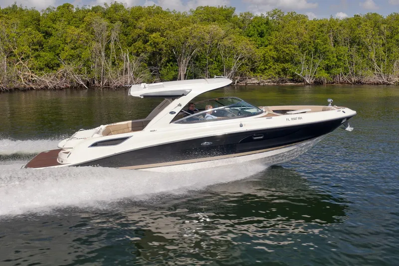  Yacht Photos Pics 2016 Sea Ray 350 SLX cruising on a calm lake with lush green shoreline.