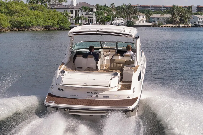  Yacht Photos Pics 2016 Sea Ray 350 SLX cruising on a scenic waterway near luxury homes.