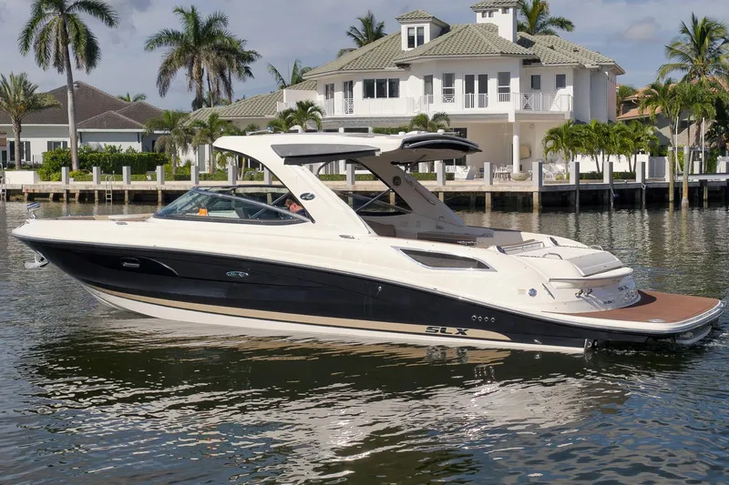  Yacht Photos Pics 2016 Sea Ray 350 SLX boat docked near a luxurious waterfront home.