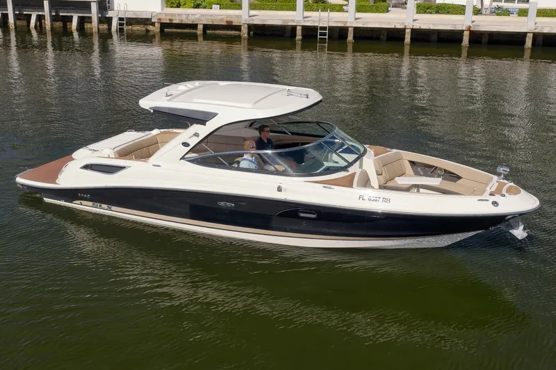  Yacht Photos Pics 2016 Sea Ray 350 SLX boat cruising on calm water near a dock.