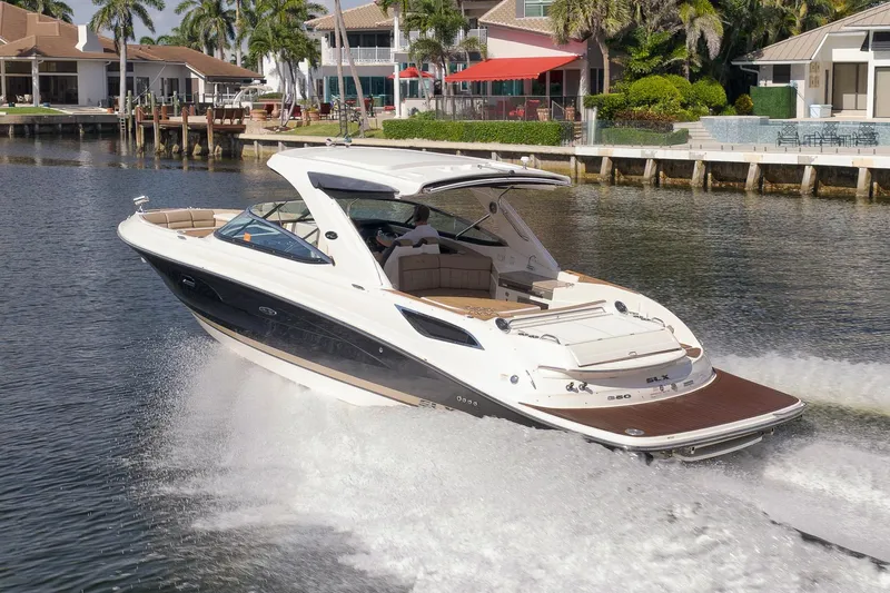  Yacht Photos Pics 2016 Sea Ray 350 SLX cruising on a scenic waterfront with luxury homes.