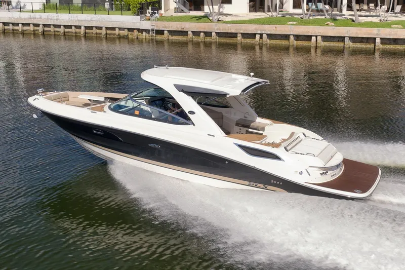  Yacht Photos Pics 2016 Sea Ray 350 SLX cruising on a calm waterway, showcasing sleek design and luxury features.