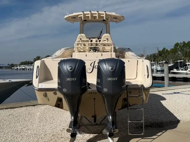  Yacht Photos Pics 2021 Grady-White Canyon 306 boat with dual 300 horsepower engines, docked by the shore.