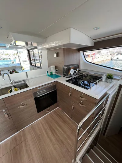  Yacht Photos Pics Modern kitchen interior on 2023 Bali 4.6 yacht with wood cabinetry and ocean view.