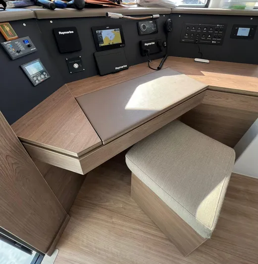  Yacht Photos Pics 2023 Bali 4.6 yacht interior with navigation equipment and wooden desk.