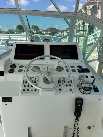  Yacht Photos Pics Helm of 2000 Cabo 31 Express boat with navigation controls and steering wheel.