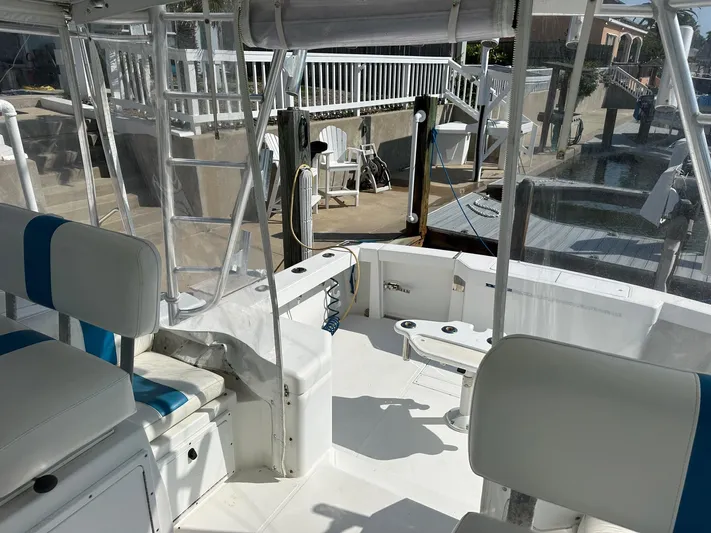  Yacht Photos Pics Interior view of a 2000 Cabo 31 Express boat docked at a marina.