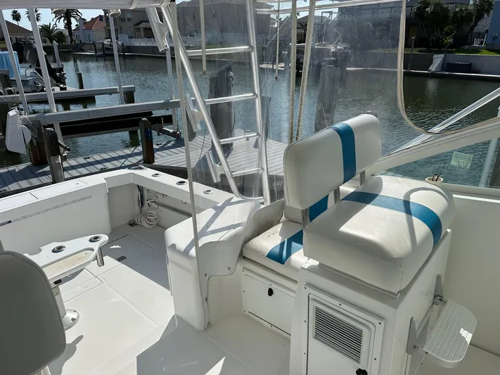  Yacht Photos Pics Cabo 31 Express 2000 boat interior with seating and dock view.