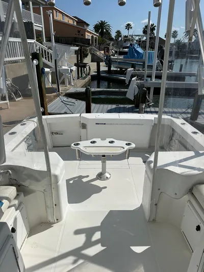  Yacht Photos Pics 2000 Cabo 31 Express boat docked at marina, sunny day, palm trees in background.