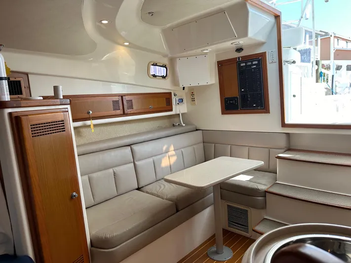  Yacht Photos Pics Interior of 2000 Cabo 31 Express boat with beige seating and wooden accents.