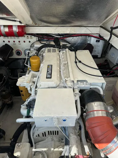  Yacht Photos Pics Engine compartment of a 2000 Cabo 31 Express boat, featuring a well-maintained diesel engine.