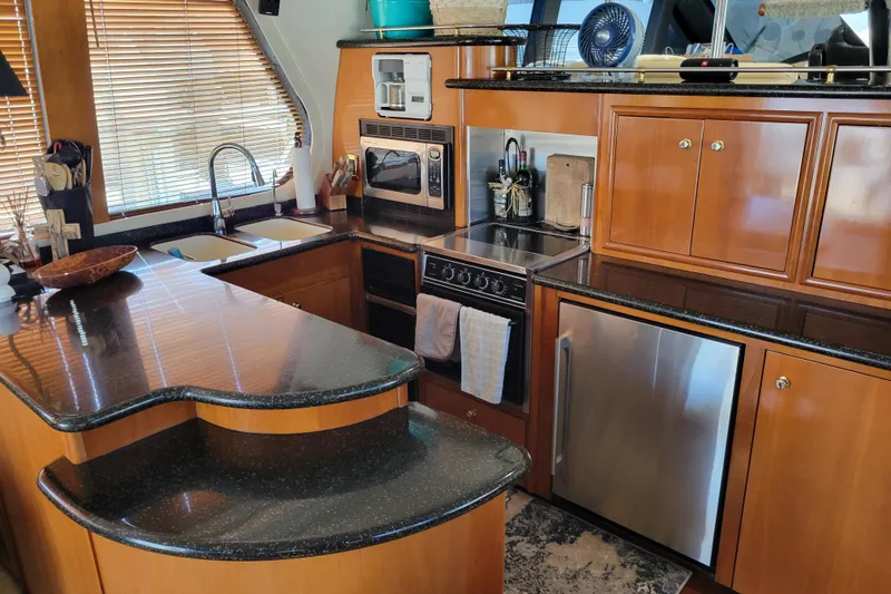  Yacht Photos Pics Luxurious kitchen interior of 2001 Carver 570 Voyager Pilothouse yacht with modern appliances.