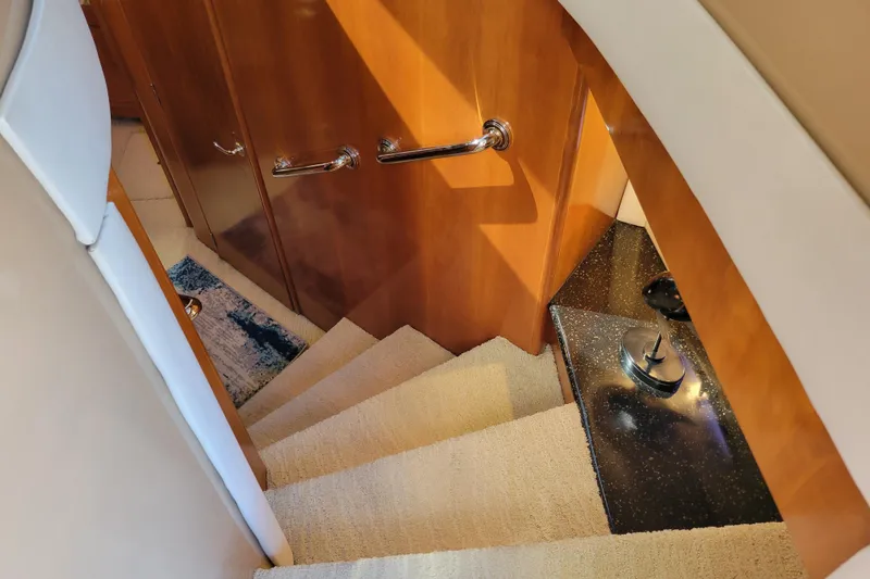  Yacht Photos Pics Staircase inside 2001 Carver 570 Voyager Pilothouse with wooden paneling and carpeted steps.