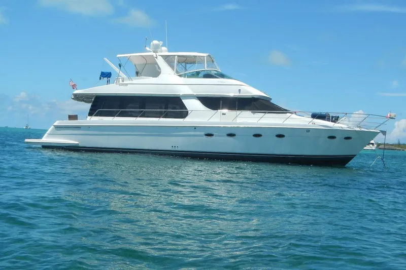  Yacht Photos Pics 2001 Carver 570 Voyager Pilothouse yacht on blue ocean water.