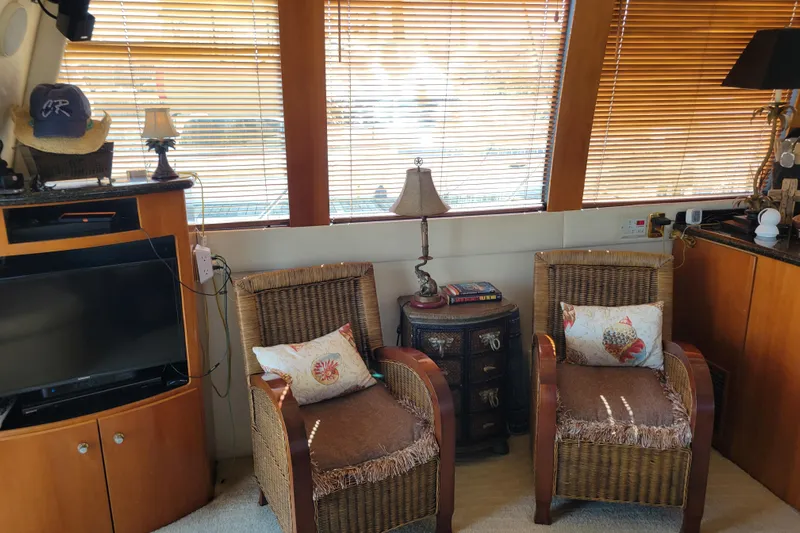  Yacht Photos Pics Interior of 2001 Carver 570 Voyager Pilothouse with wicker chairs and wooden blinds.