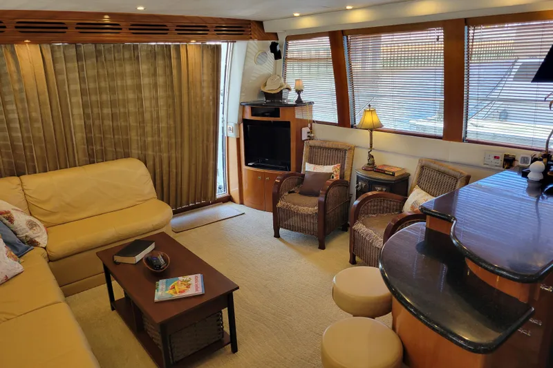  Yacht Photos Pics Luxurious interior of 2001 Carver 570 Voyager Pilothouse with cozy seating and elegant decor.