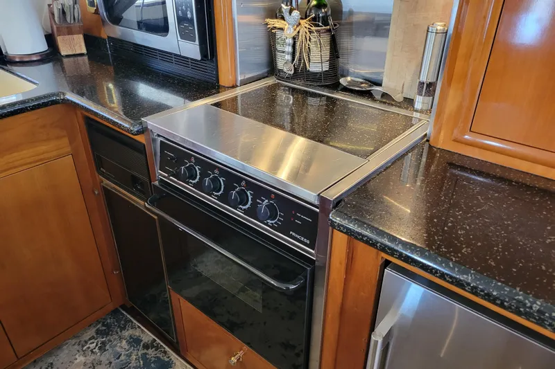  Yacht Photos Pics Galley kitchen in 2001 Carver 570 Voyager Pilothouse with stove and microwave.
