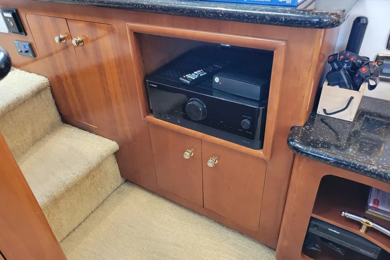  Yacht Photos Pics Interior of 2001 Carver 570 Voyager Pilothouse with wooden cabinetry and electronic equipment.