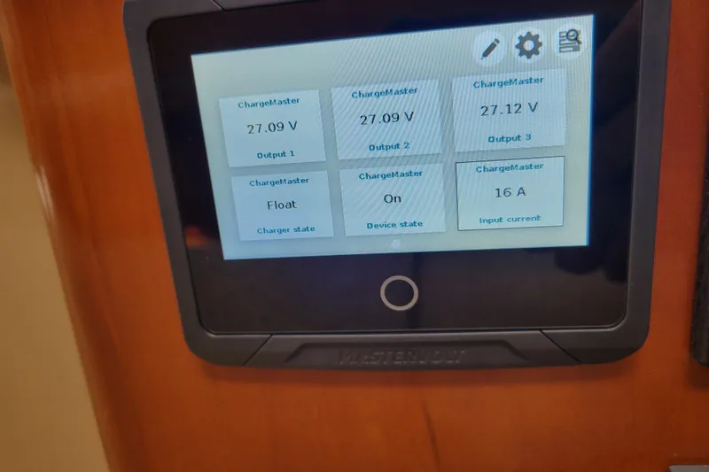  Yacht Photos Pics Display screen on 2001 Carver 570 Voyager Pilothouse showing ChargeMaster voltage and current.