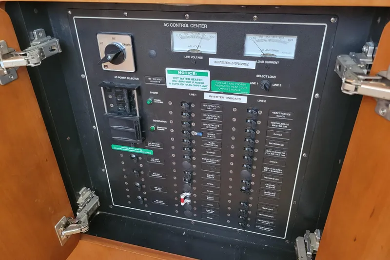  Yacht Photos Pics AC control panel of 2001 Carver 570 Voyager Pilothouse with switches and meters.
