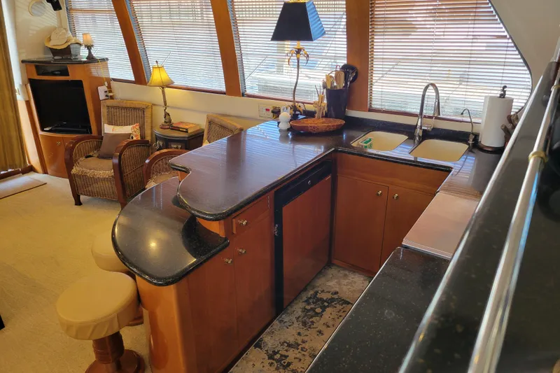  Yacht Photos Pics Luxurious 2001 Carver 570 Voyager Pilothouse interior with elegant kitchen and seating area.