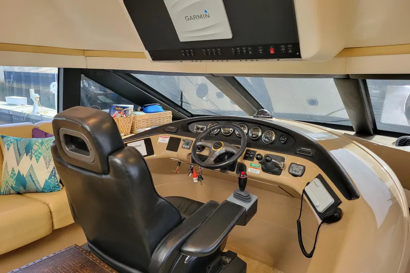  Yacht Photos Pics Interior of 2001 Carver 570 Voyager Pilothouse with steering controls and navigation equipment.