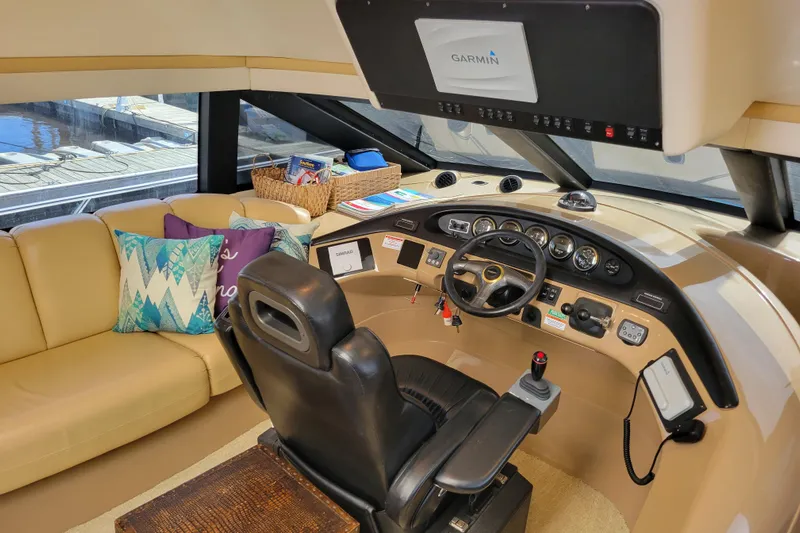  Yacht Photos Pics Pilothouse interior of 2001 Carver 570 Voyager with helm, seating, and navigation equipment.