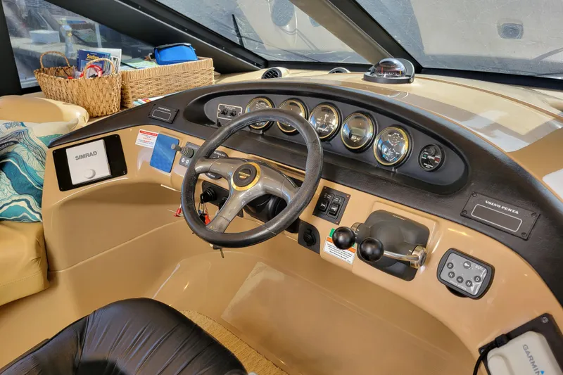  Yacht Photos Pics Interior helm of 2001 Carver 570 Voyager Pilothouse with steering wheel and navigation instruments.