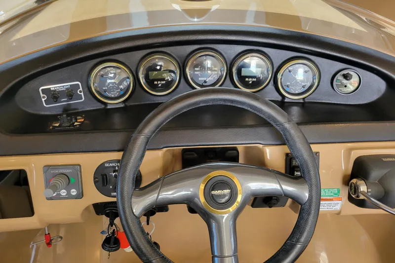  Yacht Photos Pics Dashboard of 2001 Carver 570 Voyager Pilothouse with gauges and steering wheel.