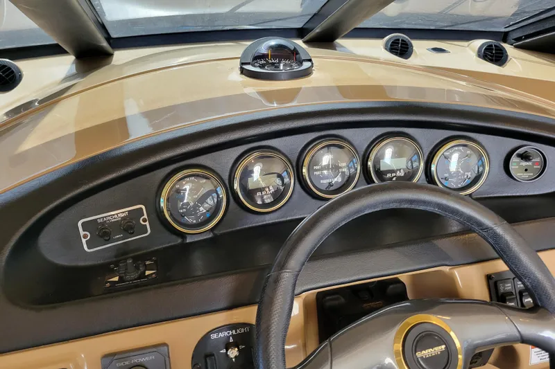  Yacht Photos Pics Dashboard of 2001 Carver 570 Voyager Pilothouse with gauges and steering wheel.