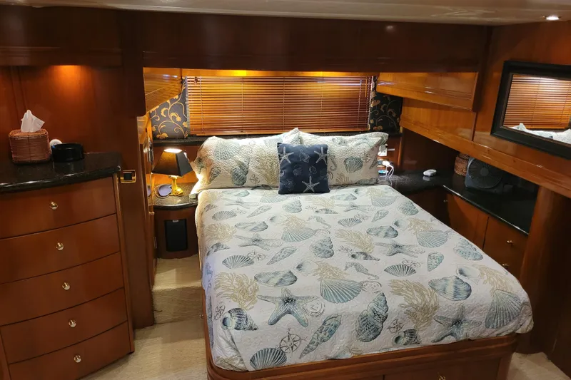  Yacht Photos Pics Luxurious bedroom interior of 2001 Carver 570 Voyager Pilothouse yacht with elegant wood finishes.